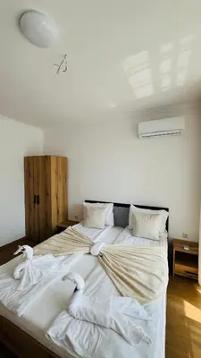 a large bed with white sheets and pillows on it at ASTORIA II Apartment 54 One Bedroom in Elenite