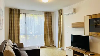 a living room with a couch and a flat screen tv at ASTORIA II Apartment 24 One Bedroom in Elenite