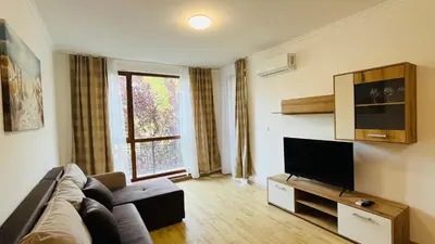 a living room with a couch and a flat screen tv at ASTORIA II Apartment 24 One Bedroom in Elenite