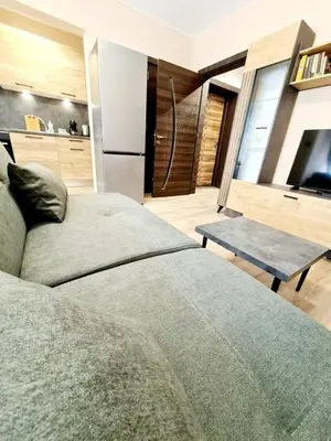 a bedroom with a bed and a tv and a table at Fresh & Cozy Flat Near Varna Cathedral in Varna City