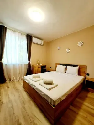 a bedroom with a large bed and a window at Fresh & Cozy Flat Near Varna Cathedral in Varna City
