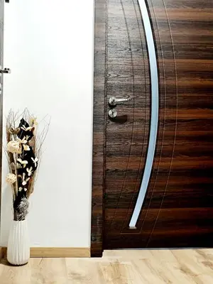 a wooden door with a vase of flowers in a room at Fresh & Cozy Flat Near Varna Cathedral in Varna City