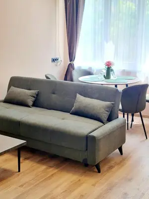 a living room with a couch and a table at Fresh & Cozy Flat Near Varna Cathedral in Varna City
