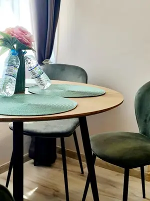 a table with two chairs and two water bottles on it at Fresh & Cozy Flat Near Varna Cathedral in Varna City