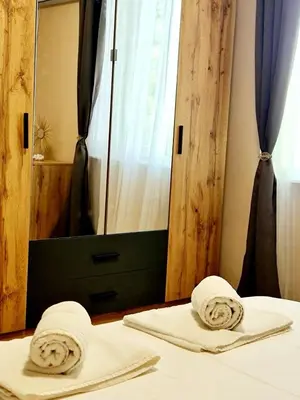 two towels on a bed in front of a mirror at Fresh & Cozy Flat Near Varna Cathedral in Varna City
