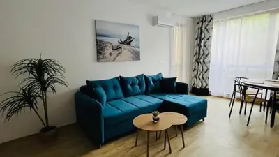 a living room with a blue couch and a table at ASTORIA II Apartment 13 One Bedroom Parter in Elenite