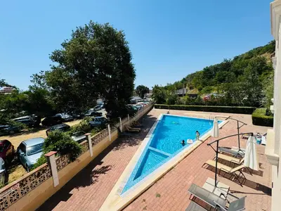 a swimming pool next to a parking lot at ASTORIA II Apartment 23 One Bedroom in Elenite