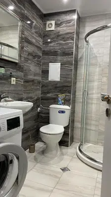 a bathroom with a toilet and a sink and a shower at Ipanema Beach - new - luxury first line - sea view in Sveti Vlas