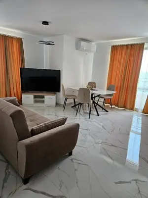 a living room with a couch and a table at Ipanema Beach - new - luxury first line - sea view in Sveti Vlas