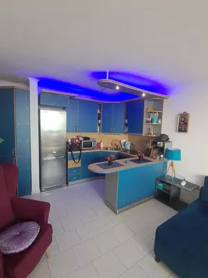 a kitchen with blue cabinets and a blue ceiling at Yacht Port apartment #sea view# in Sveti Vlas