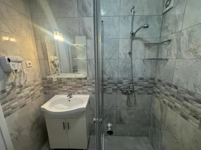a bathroom with a shower and a sink at Allure by the Sea in Primorsko