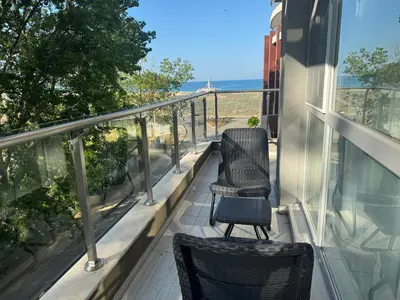 two chairs on a balcony with a view of the ocean at Allure by the Sea in Primorsko