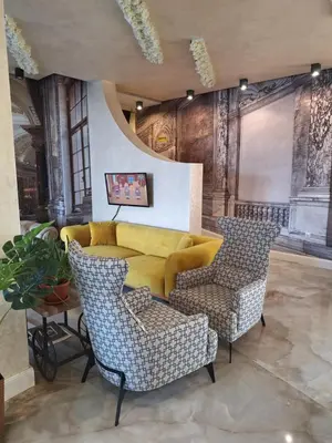 a lobby with two chairs and a yellow couch at Allure by the Sea in Primorsko