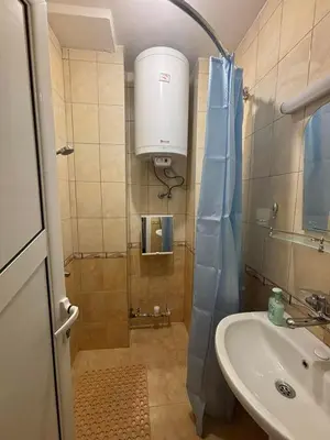 a small bathroom with a sink and a shower at Апартамент за гости Весела in Burgas City
