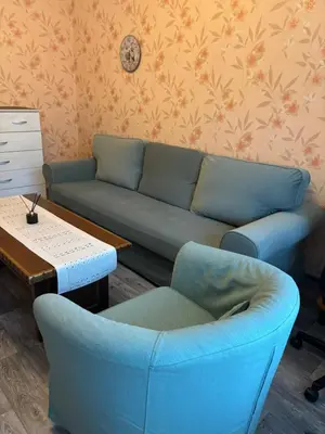 a living room with a couch and a table at Апартамент за гости Весела in Burgas City