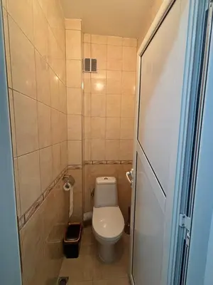 a small bathroom with a toilet and a shower at Апартамент за гости Весела in Burgas City