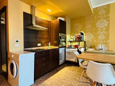 a kitchen with a table and a stove top oven at Royal Barcelo G404 Sunny Beach in Sunny Beach