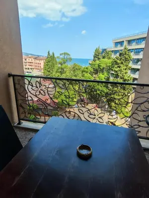 a table on a balcony with a view of the ocean at Royal Barcelo G404 Sunny Beach in Sunny Beach