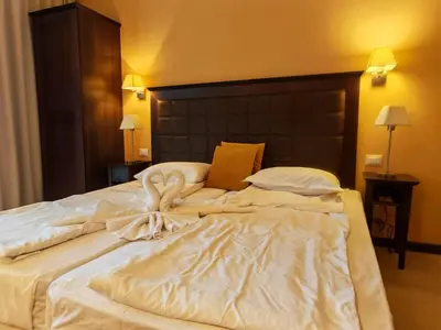 a large white bed with a bow on it at Royal Barcelo G404 Sunny Beach in Sunny Beach