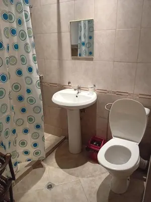 a bathroom with a toilet and a sink at Студио във Виго Панорама Несебър in Nesebar