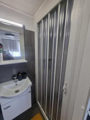 a bathroom with a sink and a shower at Roman panorama - Varna in Varna City