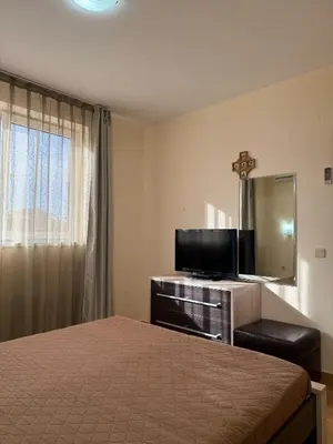 a bedroom with a bed and a tv and a mirror at Sky dreams Sveti Vlas in Sveti Vlas