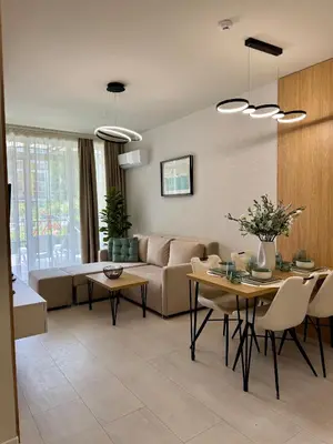 a living room with a couch and a table at Domenico Luxury Apartments in Sunny Beach