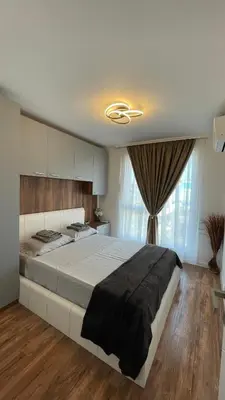 a bedroom with a large bed in a room at Тони апартмент in Burgas City