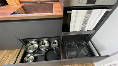 a drawer in a kitchen with pots and pans at Тони апартмент in Burgas City