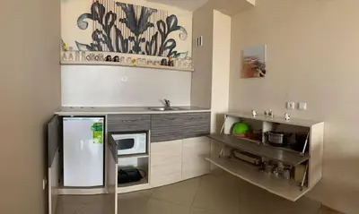 a kitchen with a sink and a microwave at Sozopoli Hills A-17 sea view in Sozopol