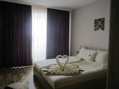 a bedroom with two white swans on a bed at Sozopoli Hills A-17 sea view in Sozopol