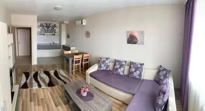 a living room with a purple couch and a table at Sozopoli Hills A-17 sea view in Sozopol