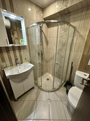 a bathroom with a shower and a sink and a toilet at PSB Apartment in Paradiso in Nesebar