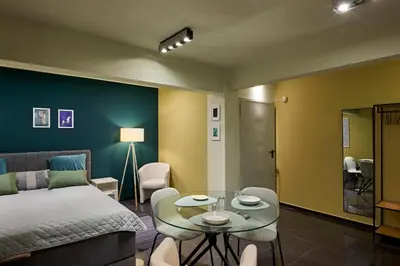a bedroom with a bed and a table and chairs at Beauty 1 FREE PARKING in Burgas City