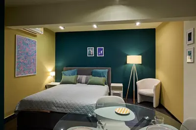 a bedroom with a bed and a blue wall at Beauty 1 FREE PARKING in Burgas City