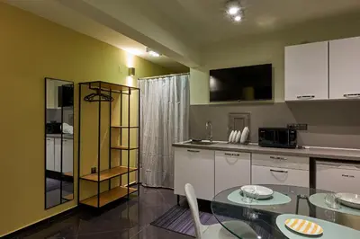 a kitchen with a glass table and a counter top at Beauty 1 FREE PARKING in Burgas City