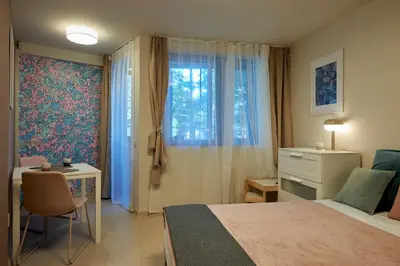a bedroom with a bed and a desk and a window at Beauty 2 FREE PARKING in Burgas City