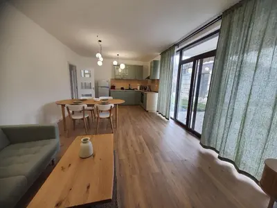 a living room with a couch and a table at Вила Фамилия - Villa Family in Lozenets