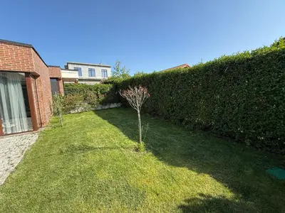 a garden with two small trees in the grass at Вила Фамилия - Villa Family in Lozenets