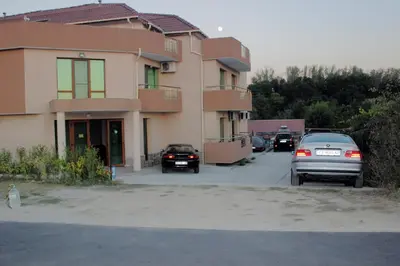 a group of cars parked in front of a building at Tangra Guest House in Arapya