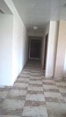 an empty hallway of an empty building with a hallway at Tangra Guest House in Arapya