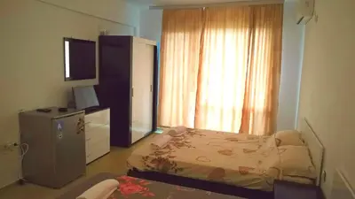 a bedroom with a bed and a television and a window at Tangra Guest House in Arapya