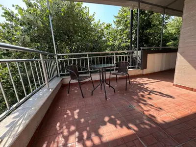 a patio with two chairs and a table on a balcony at VP Palazzo Nesebar in Nesebar