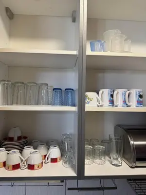 a pantry filled with lots of dishes and cups at VP Palazzo Nesebar in Nesebar