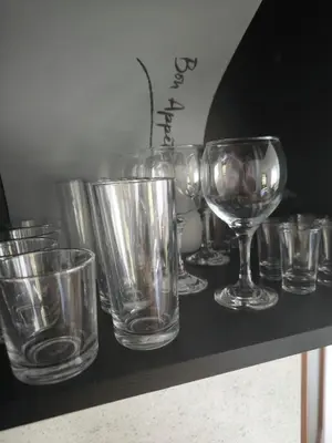 a bunch of empty glasses sitting on a table at Светлая квартира на 4 этаже in Ravda