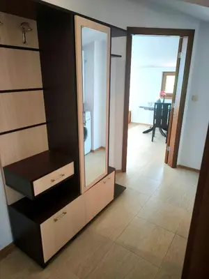 a dresser with a mirror in a room at Светлая квартира на 4 этаже in Ravda