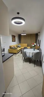 a living room with a table and a couch at Sunny Beach Blue Perl in Sunny Beach
