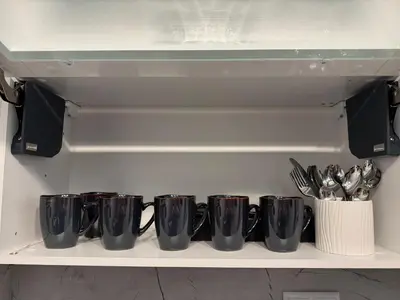 a row of coffee cups sitting on a shelf at Luxury seaside apartment with seaview in Sveti Vlas