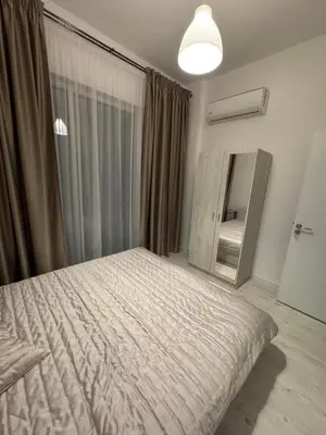 a bedroom with a large bed and a mirror at Luxury seaside apartment with seaview in Sveti Vlas