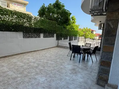a patio with a table and chairs and a fence at Luxury seaside apartment with seaview in Sveti Vlas